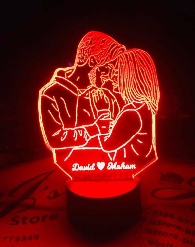 Customized LED Picture Lamp - a unique and personalized gift item. The lamp is made up of a wooden base and a rectangular glass panel, on which a customized picture is printed. The picture is illuminated by LED lights, which emit a warm and cozy glow.