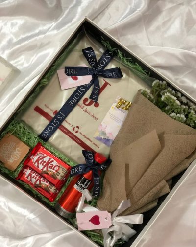 id Gift-Boxes for Men - Gold: Unstitched Suit, Kit Kats, Tasbeeh & Ittar Box, Bouquet, Dunhill Desire Deodorant. Premium gift box dimensions 16 * 16 * 5 on white silk background.