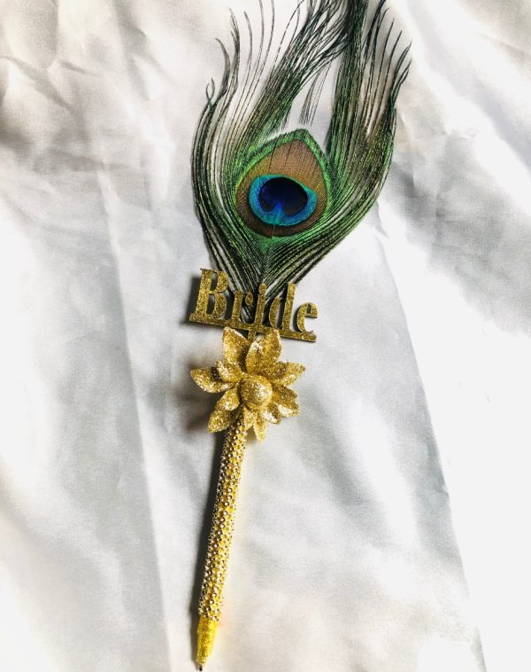Beautiful peacock feathered Nikkah Pen For Bride, white gold colored Bride written on it. It has a gold flower on it.