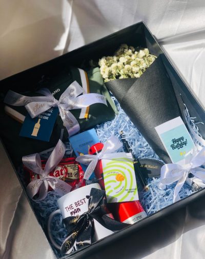 "Man Crush Gift Box with Olive Green Polo Shirt, Customized Mug, Dunhill Desire Red Deodorant, Leather Keychain, Name Engraved Pen, KitKat Chocolate Bars, and Baby's Breath Bouquet on White Silk Background