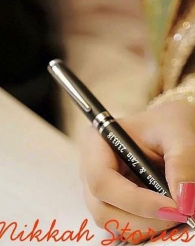 Bride signing with Name Engraved Nikkah Pen on her nikkah day.