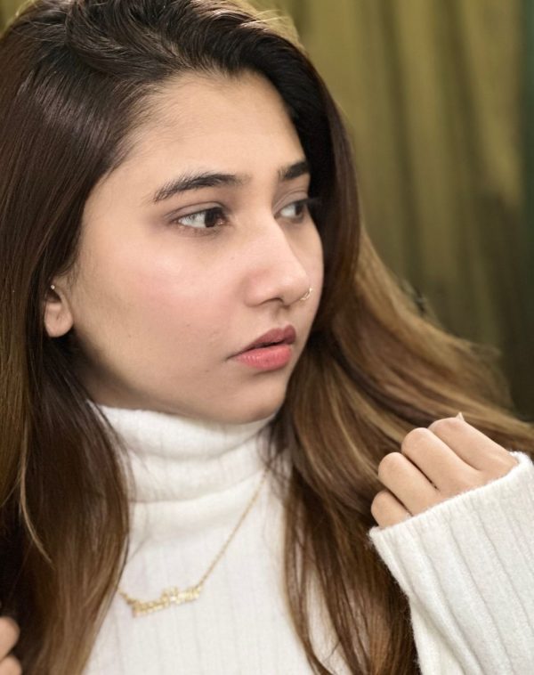 Close-up of Fizzah Amir wearing the Double Name Gold-Plated Necklace, with her face turned away from the camera.