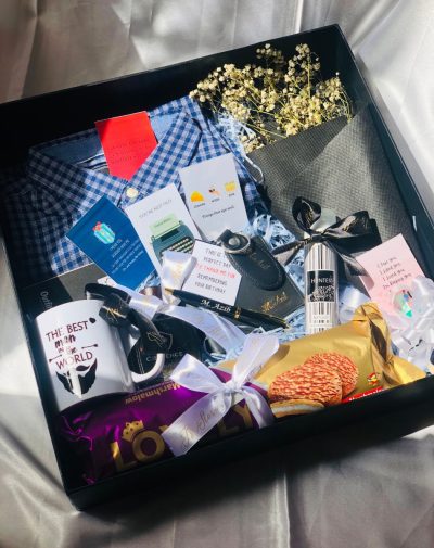 Whimsical Gift Box: Branded Checkered Shirt, Customized Leather Wallet, Keychain, and Pen, Customized White Mug, Baby's Breath Bouquet, Cocoa-Coated Sandwich Biscuit, Branded Perfume