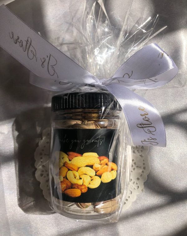 Nuts Jar with Elegant Packaging and White Ribbon on White Background