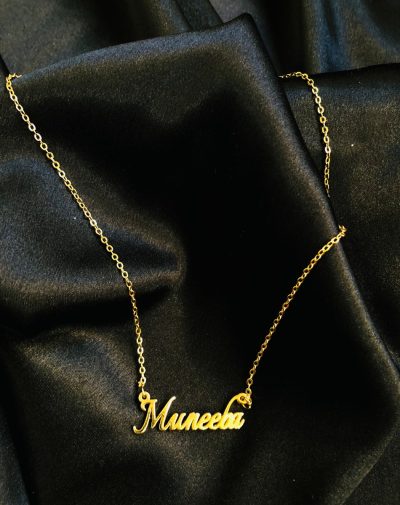 Single Name Gold-Plated Necklace on a black background.