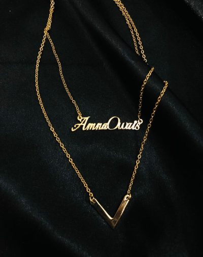 "Double Name Double Chain Silver-Plated Necklace. An image of a silver-plated necklace featuring two chains with personalized pendants hanging at different lengths. The pendants have engraved names on it.