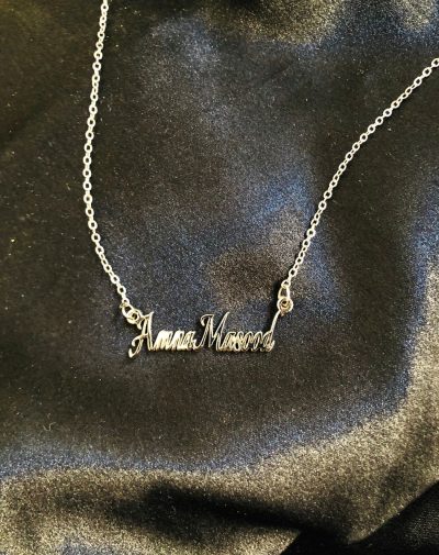 Double Name Silver-Plated Necklace. An image of a silver-plated necklace with a personalized pendant that has engraved name hanging from a chain.