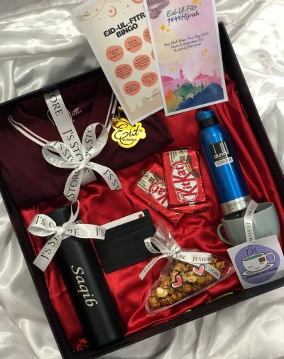 Premium Eid Celebration Combo Pack with POLO shirt, Dunhill Desire Blue deodorant, customized temperature bottle, leather card holder, KitKats, salted caramel popcorn, bingo game card, Eid-ul-Fitr greeting card, and tea cup with 2 flavored tea bags in a 16 * 16 * 4 inches box with ribbons, mini cards, and imported shredded papers.
