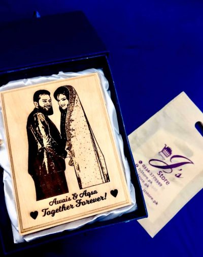 The wooden frame is in the shape of a 6 * 8 plaque, and it features a customized picture engraving of a couple, along with engraved text specifically written for an anniversary. The wooden frame itself has a natural, warm tone, and the intricate engraving highlights the unique features of the couple in the picture.
