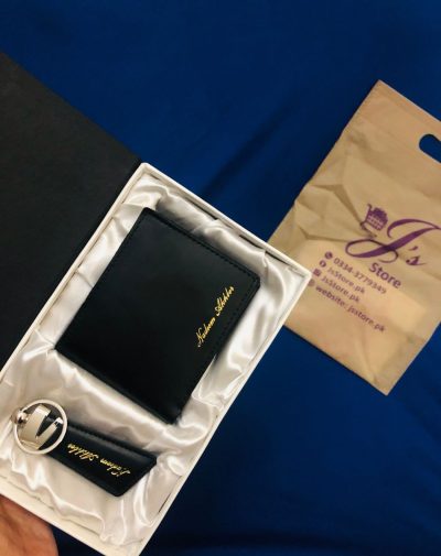 Personalized black leather wallet and keychain gift set, engraved with recipient's name in golden color, presented in a brown box.