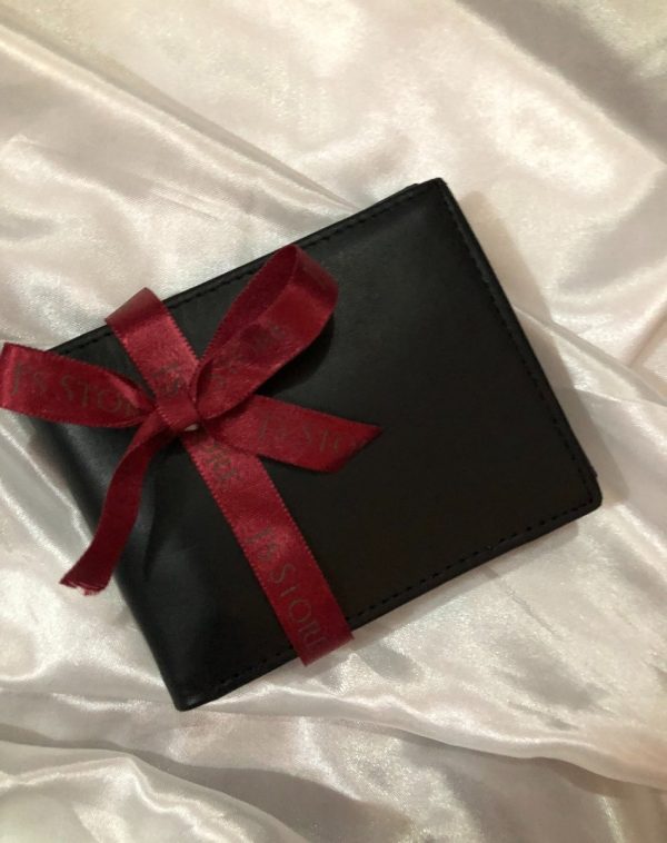 Plain Black Leather Wallet - A premium quality leather wallet by J's Store, placed on a white silk cloth and elegantly wrapped with a red ribbon.