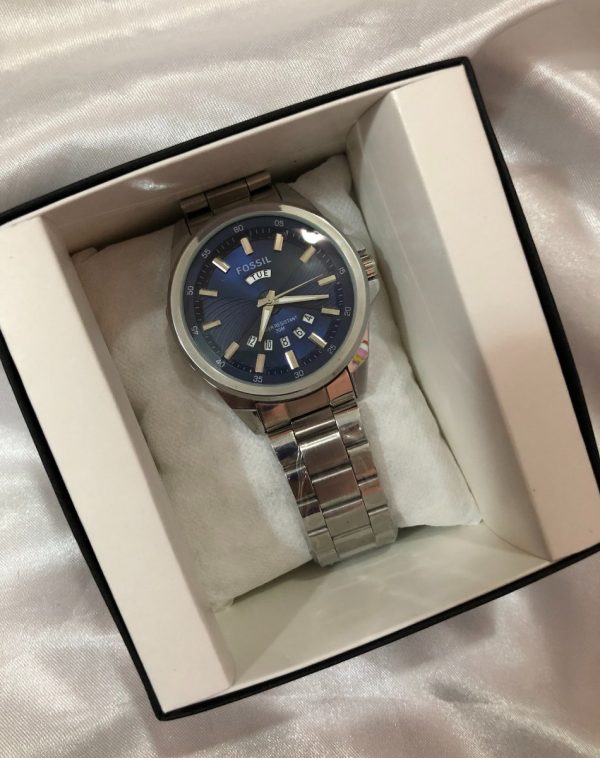 Fossil Watch with Silver Chain and Black Dial carefully wrapped on a soft pillow inside its brand box.