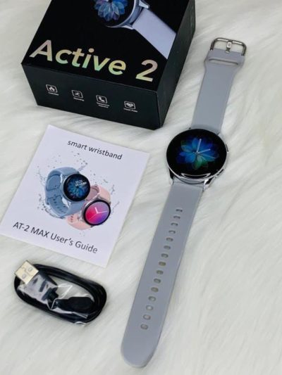 AT-2 Max Smartwatch with Grey Strap, accompanied by accessories, displayed from the front against white background.