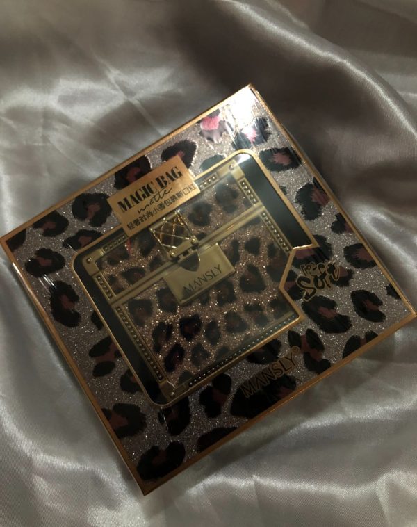 Cheetah print makeup bag with "Mansly Lipstick" brand logo visible, filled with three matte velvet lipsticks in different shades.