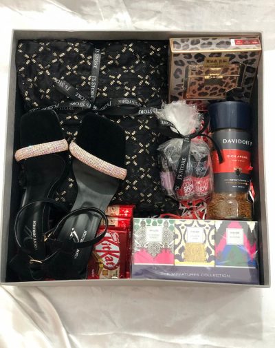 Elegant Supreme Love Luxe Box for Her - Anniversary and Birthday Gift with Vinny Jorden Heel, 3-Piece Outfit, Coffee Jar, Nail Paints, Lipstick Bag, Perfume Set, and Sweet Indulgences on White Silk Background.