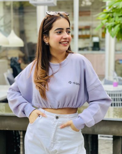 Stylish Lilac Cropped Drop Shoulder Scannable Sweatshirt with fleece material. Influencer Palvi Ramani posing in the trendsetting sweatshirt, looking away from the camera, showcasing the highest quality design.