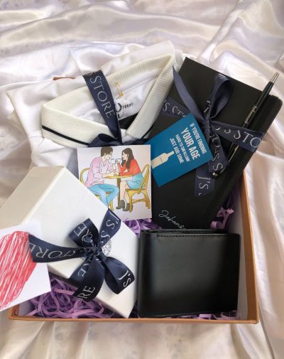 J's Store Gentleman's Essentials Box: Fred Perry polo, Versace shades, personalized leather notebook & pen, sleek wallet.