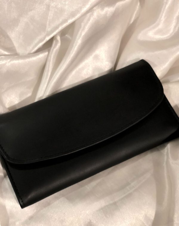 A Black Bridle Leather trifold wallet from J's Store. It features a flap closure and is crafted from premium leather. Presented against a clean white backdrop.