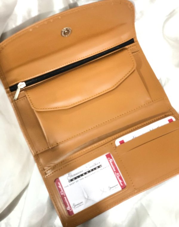 A Camel Bridle Leather trifold wallet from J's Store. It features a flap closure and is crafted from premium leather. Presented against a clean white backdrop. It has been made for convenience with lots of pockets, card slots and small coin compartment.