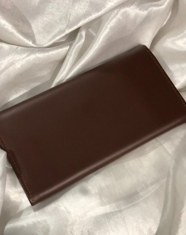 The back view of a Dark Brown Bridle Leather trifold wallet from J's Store. It features a flap closure and is crafted from premium leather. Presented against a clean white backdrop.