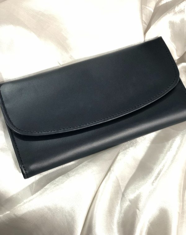 A Black Bridle Leather trifold wallet from J's Store. It features a flap closure and is crafted from premium leather. Presented against a clean white backdrop.