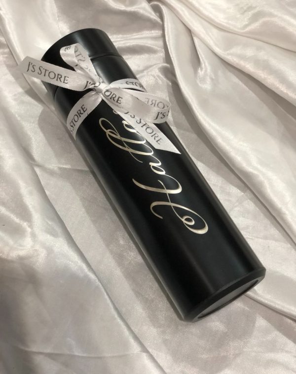 A name engraved customized temperature bottle in black colour with a decorative ribbon.