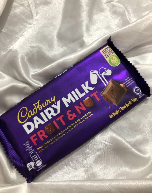 A bar of creamy Dairy Milk Fruits and Nuts chocolate. Kept against crisp silk white background.