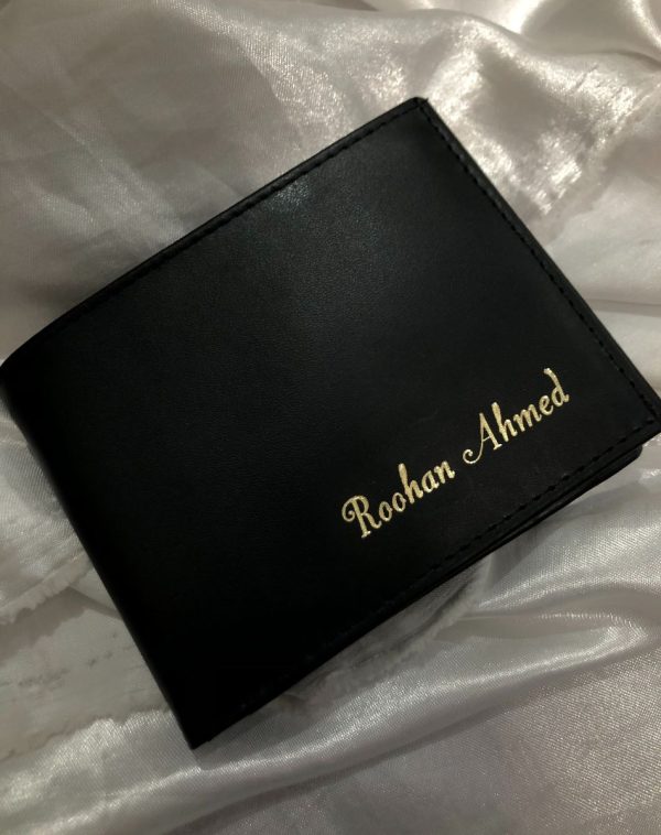 Plain Black Leather Wallet - A premium quality leather wallet by J's Store, placed on a white silk cloth and elegantly wrapped with a Name engraving