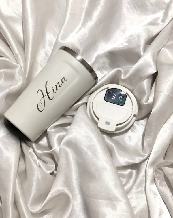 A White Coffee Tumbler with customized name engraving.