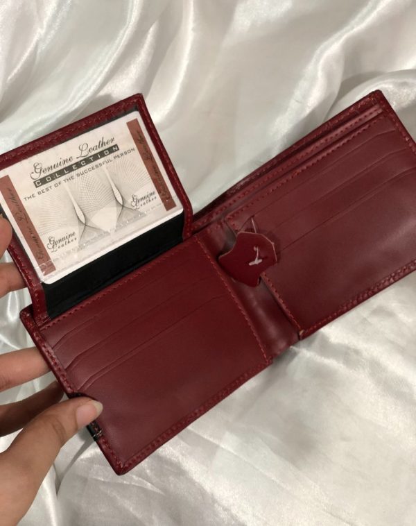 The flap of Maroon Crocodile Leather Wallet For Men has been lifted to reveal more card slots.