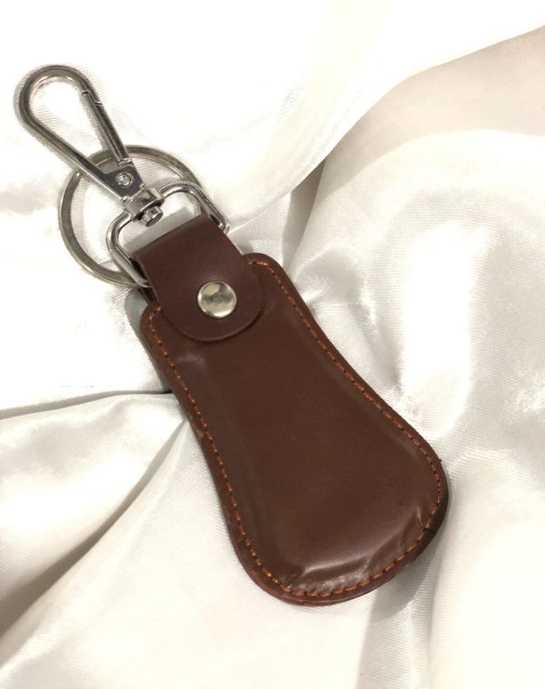 Brown Elegant Curved Leather Keychain by J's Store with timeless leather texture and a durable clasp.