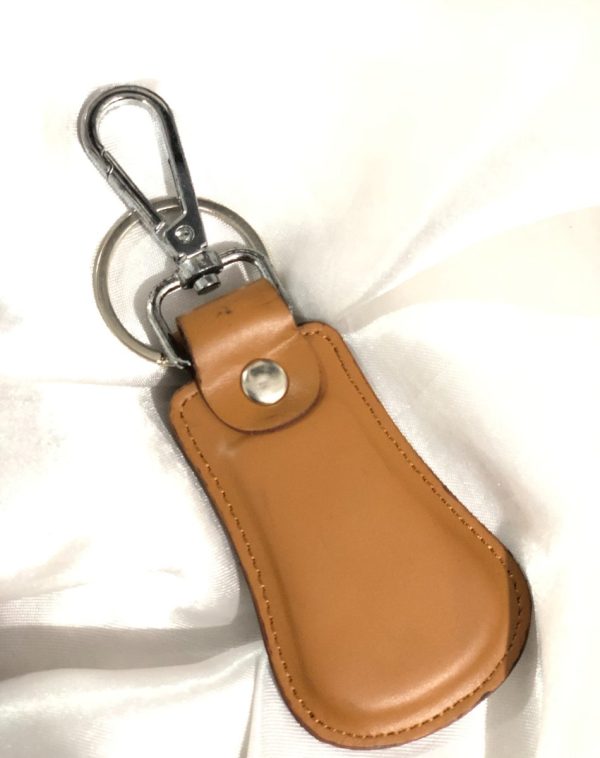 Camel Elegant Curved Leather Keychain by J's Store with a stylish leather finish and metallic accent.