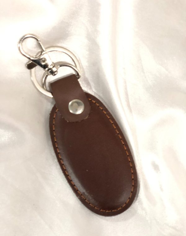 A brown Simple Leather Keychain with a silver hook, crafted for elegance and durability.
