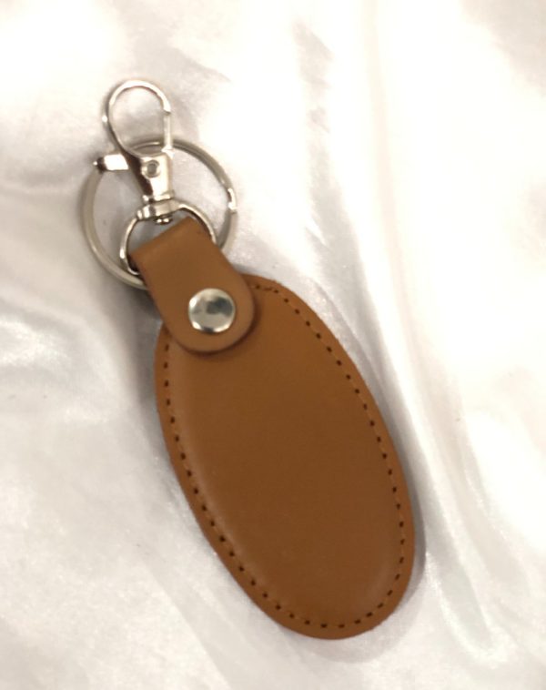 A camel-colored Simple Leather Keychain with a silver hook, blending simplicity with sophistication.