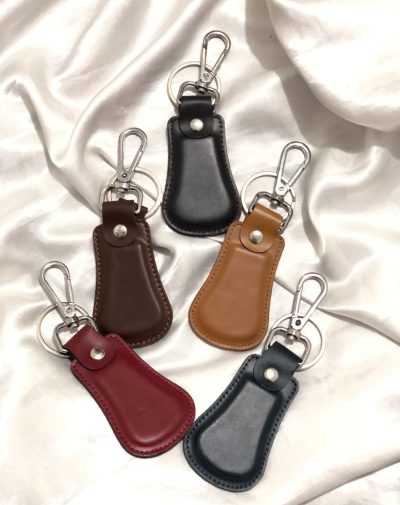 Elegant Curved Leather Keychain by J's Store in five colors, featuring a modern curved design for a refined look.