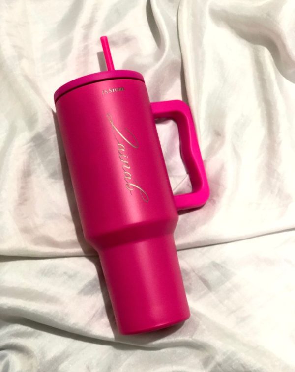 Shocking Pink Quencher Tumbler with the name 'Zainab' engraved on it, showcasing J's Store's personalization service.