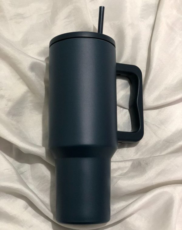 Teal Quencher Tumbler with a handle and straw, showcasing its stylish and functional design.