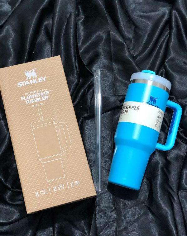 The Stanley The Quencher H2.0 Flowstate Tumbler in refreshing Sky Blue with its original packaging, showcasing the sleek design and durable construction