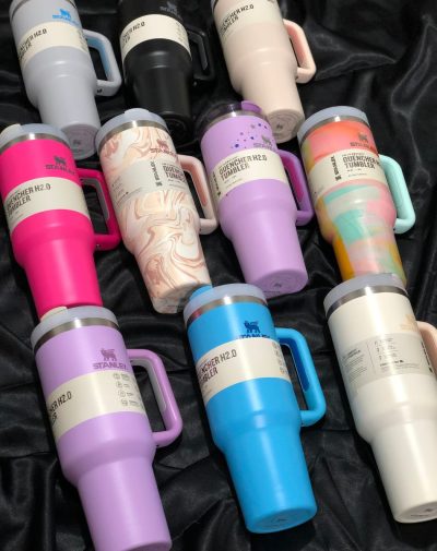 A vibrant display of The Flowstate Quencher H2.0 Tumblers in 10 stylish colors, showcasing their sleek design, sturdy handles, and durable construction.