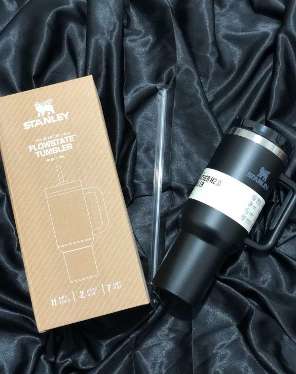 The Stanley The Quencher H2.0 Flowstate Tumbler in classic Black with its original packaging, showcasing the sleek design and durable construction.
