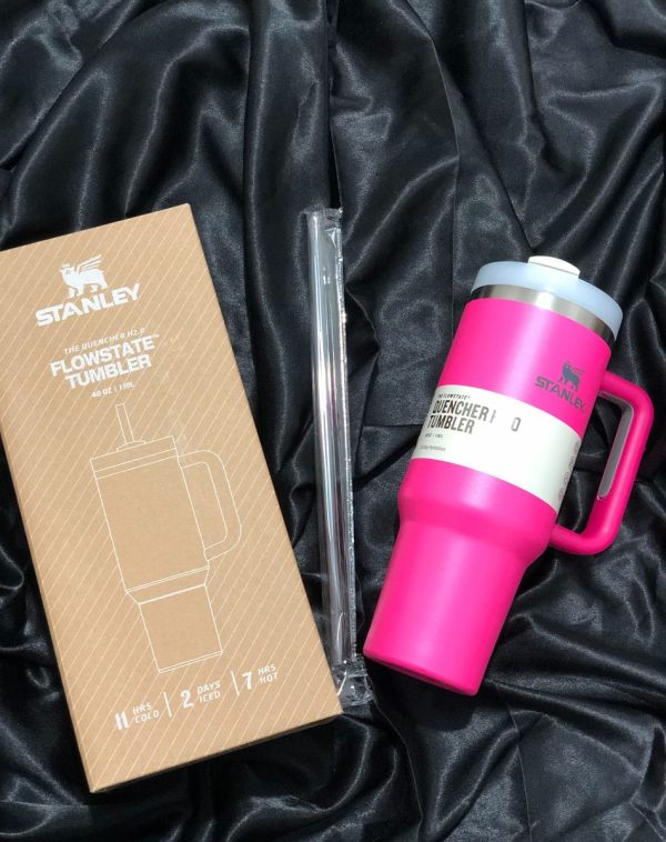 The Stanley The Quencher H2.0 Flowstate Tumbler in vibrant Fuchsia Pink with its original packaging, showcasing the sleek design and durable construction.