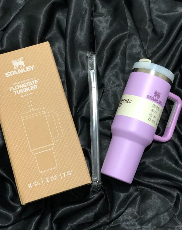 The Stanley The Quencher H2.0 Flowstate Tumbler in delicate Lilac with its original packaging, showcasing the sleek design and durable construction.