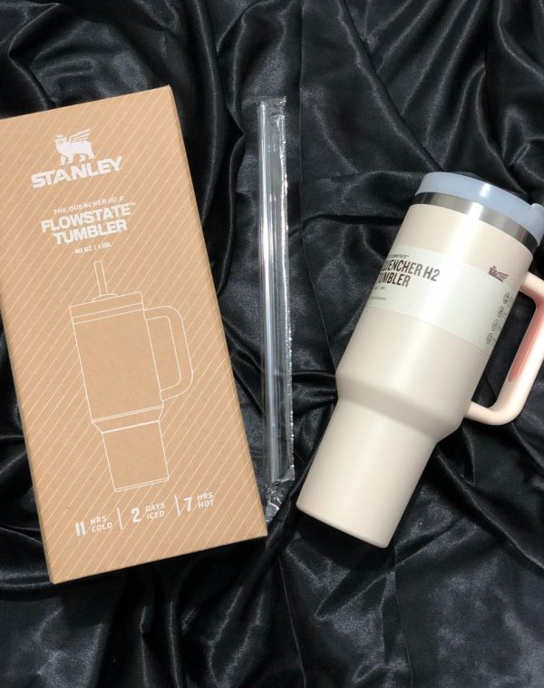 The Stanley The Quencher H2.0 Flowstate Tumbler in soft Powder Pink with its original packaging, showcasing the sleek design and durable construction.