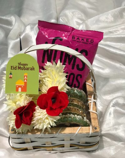 Eid Festive Fun Basket from J’s Store with nachos, a bangles set, a mehndi cone, and artificial flower garlands.