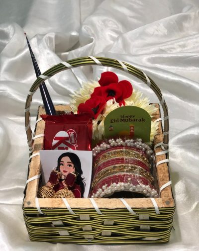 Eid Festive Jhumka Basket from J’s Store with jhumkas, a bangles set, a mehndi cone, artificial flower garlands, and a KitKat.