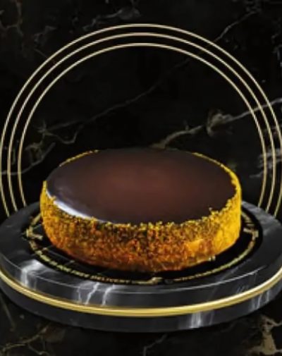 Alt Text: Three Milk Cake by J’s Store with chocolate glaze and caramel nut crust, available for online delivery in Karachi.
