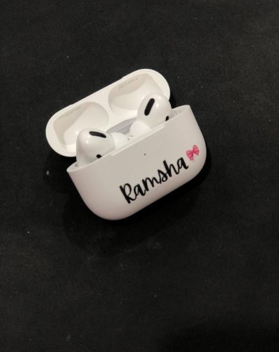 Customized Name AirPods Pro Case with wireless charging, white color, featuring the name "Ramsha" and a pink bow graphic.