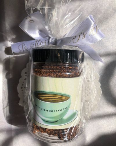 Mini Coffee Jar from J’s Store with coffee granules and a witty label, tied with a white ribbon.