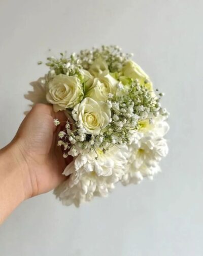 Celeste Garland wrist accessory featuring white roses chrysanthemums and baby's breath from J's Store