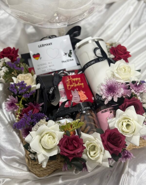 Close up details of Luxe Serenade Gift Basket showing floral arrangement, personalized tumbler, and gourmet jars in Karachi.